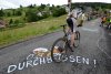 Mountainbiker, Fahrrad, Straßenkreide, Durchbeissen, Wiese, Flatterband, Zuschauer, Häuser, Schwarzwald, Hintern